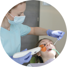 Photo of hygienist working on a patient's teeth